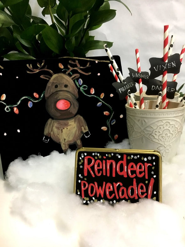 Image of Black Chalkboard Paper from Chalk Ink with illustration of reindeer and little gold rimmed chalkboard with chalk ink words Reindeer Powerade in color clown nose red