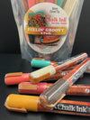 Closeup product image of chalk ink liquid chalk markers feelin groovy variety pack and packaging in the background