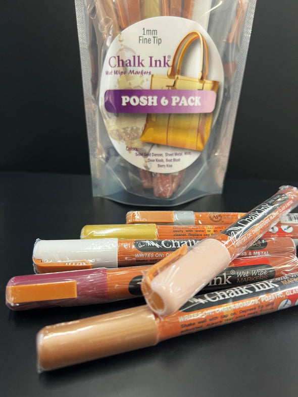 Closeup product image of fine tip chalk ink liquid chalk markers in posh colors laying on black table in front of chalk ink posh pack packaging