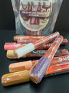 Closeup product image of chalk ink liquid chalk marker variety pack on a black table in front of skip and go naked chalk marker packaging