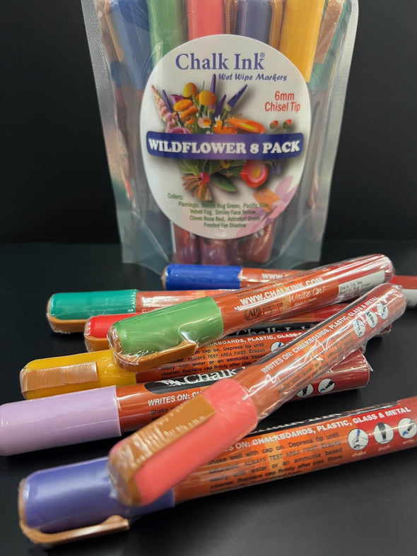 Closeup product image of chalk ink wildflower pack liquid chalk markers with packaging standing in the background