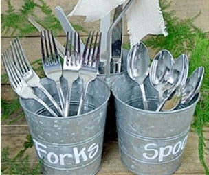 Image of metal buckets holding spoons and forks with the words forks and spoons written on the side using chalk ink white liquid chalk markers
