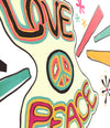 Closeup of artwork with the words love and peace and peace sign drawn on a white chalkboard using chalk ink liquid chalk feelin groovy markers
